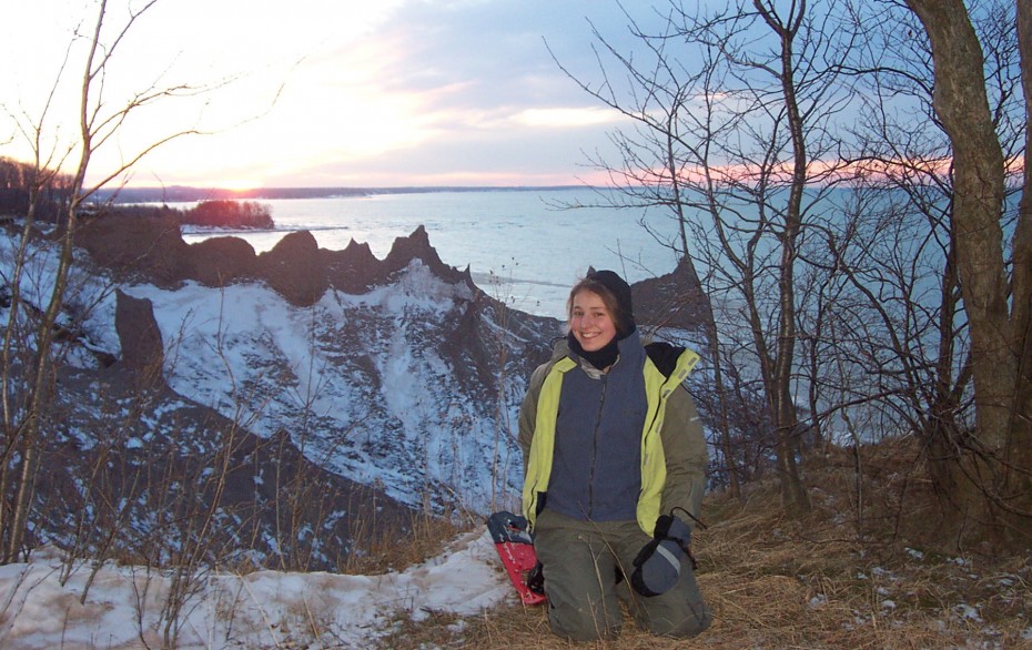 Sun sets on Lake Ontario behind spectacular Chimney Bluffs and the author.