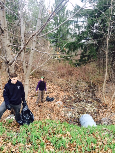 Volunteers work together to clear this stream of trash
