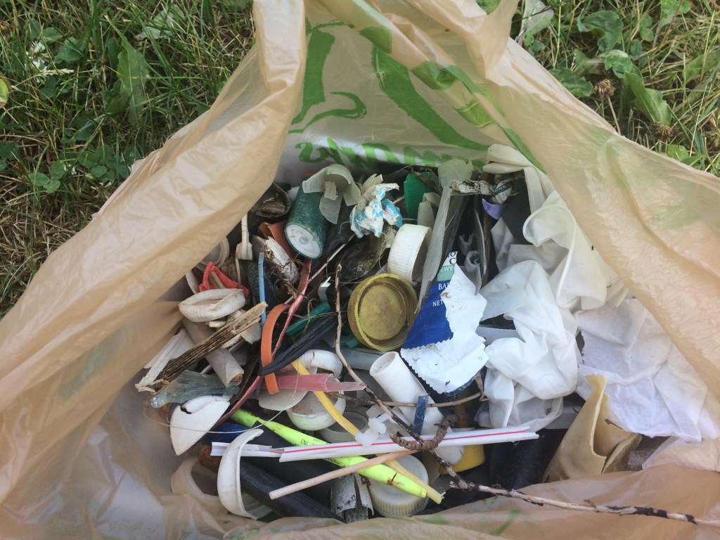 Small Plastic Fills A Bag Quickly As It Is Extracted From a Favorite Fishing Access Site